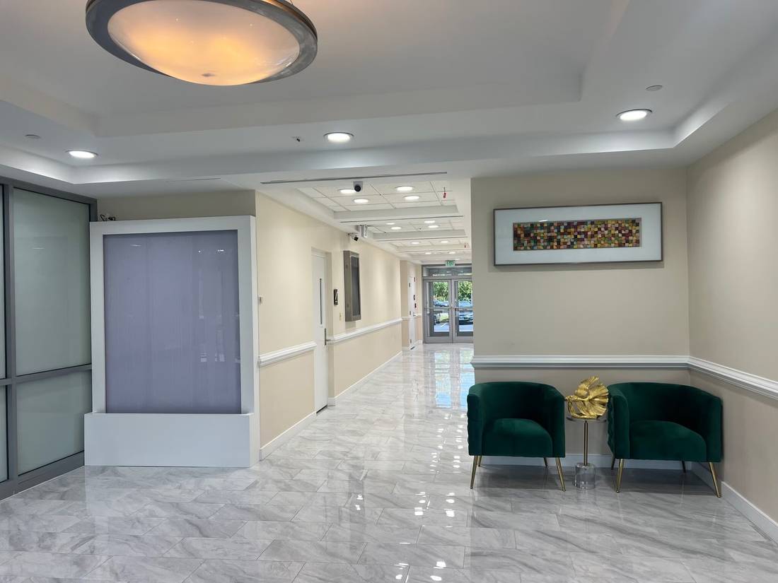 Refreshed main lobby at 4201 Mitchellville Road with marble floors and lounge seating